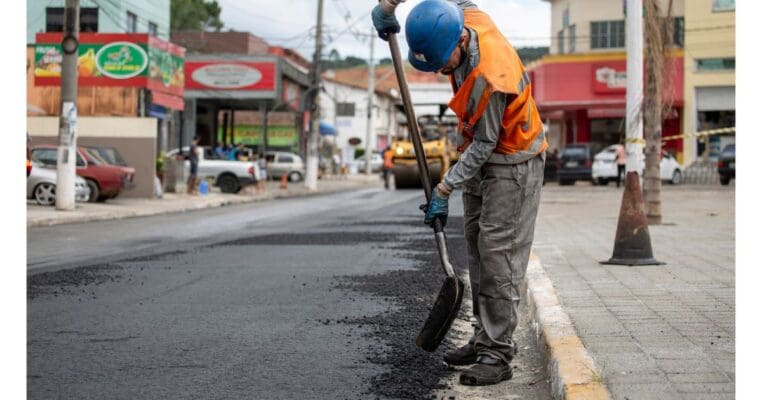 Worker installing asphalt pavement